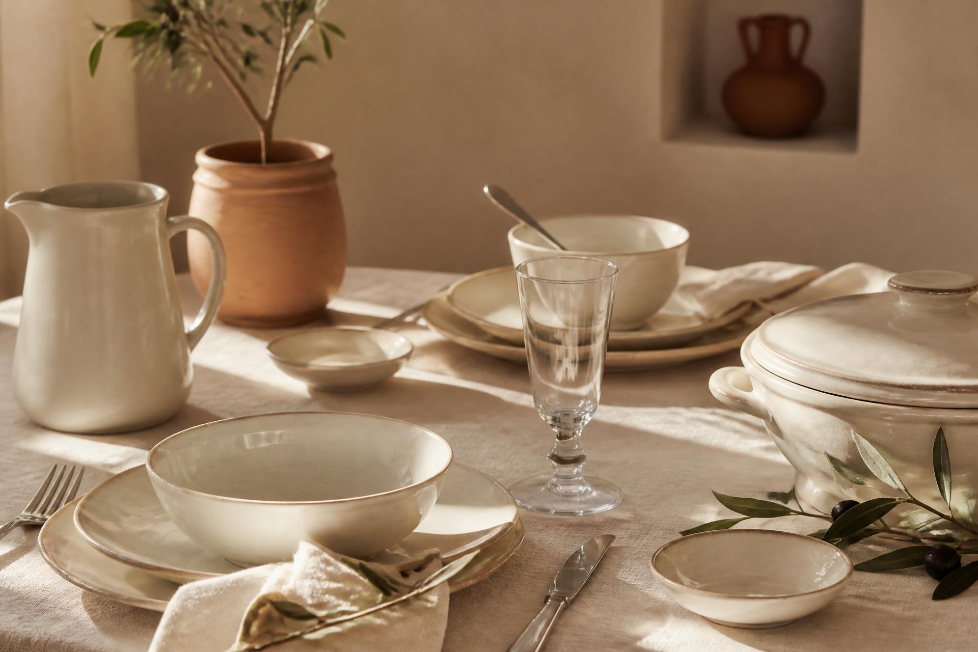 An elegantly styled dining table with warm ivory Cadamba ceramic tableware